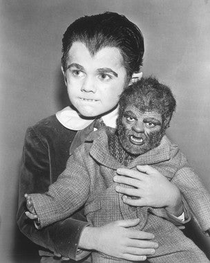 A collection of Munsters action figures displayed in a vintage setting.