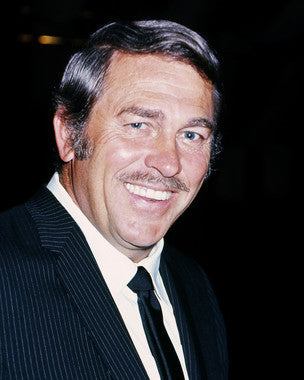 Howard Keel performing in a classic musical theater production, showcasing his powerful vocal talent.