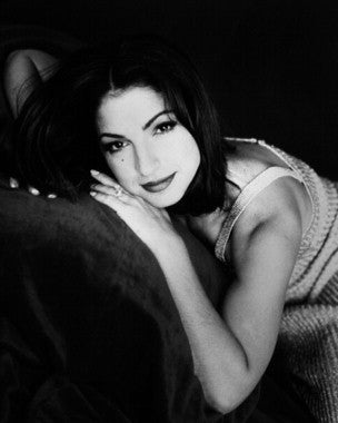 Gloria Estefan performing live on stage with energetic dance moves