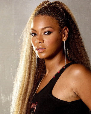 Beyonce performing live on stage with vibrant lighting and energetic audience