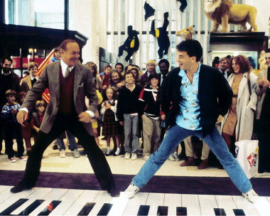 Tom Hanks in a joyful scene from the comedy film Big, showcasing his playful character.