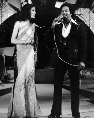 Marilyn McCoo performing live with a vibrant audience at her concert.