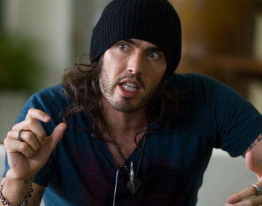 Russell Brand performing live on stage during his stand-up tour