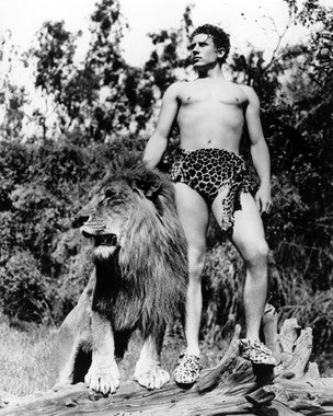Front view of Glenn Morris Tarzan figure posed heroically on jungle terrain