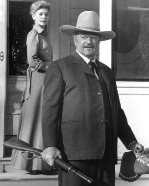 John Wayne in a classic western film, showcasing his iconic role.