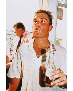 Front view of Shane Warne autographed cricket ball on display.