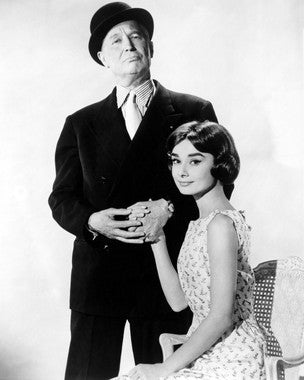 Audrey Hepburn smiling in a romantic scene from Love in the Afternoon.