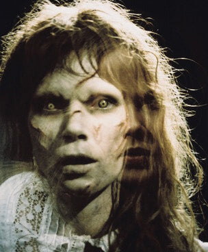 The Exorcist movie poster showcasing Linda Blair in a haunting scene.