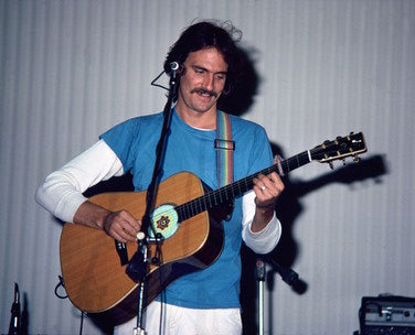 James Taylor Acoustic Guitar from a side angle, highlighting its beautiful finish and craftsmanship.