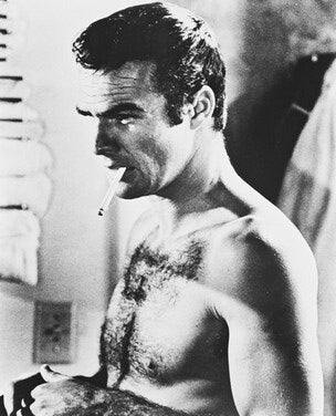 Burt Reynolds autographed photo displayed in a frame, perfect for collectors.