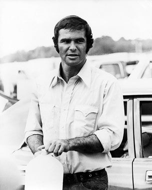 Burt Reynolds signed poster displayed in a stylish living room, perfect for movie collectors