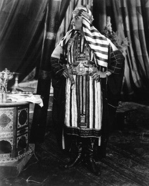 Authentic Rudolph Valentino film star autograph displayed elegantly on a wooden frame.