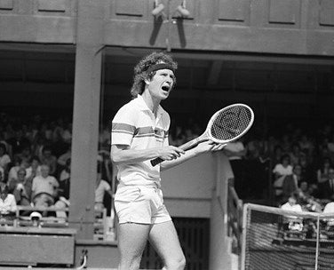 Close-up of authentic John McEnroe signed tennis memorabilia, showcasing signature detail.