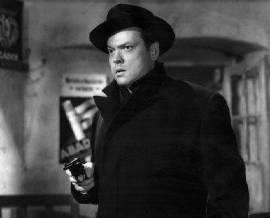 A dramatic shot from The Third Man featuring Orson Welles in a shadowy alley, embodying the essence of film noir.