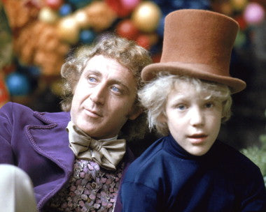 Willy Wonka in his magical chocolate factory, surrounded by delicious treats.