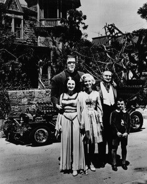 Vintage Munsters collectibles displayed on shelf, showcasing retro TV memorabilia