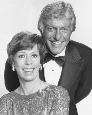 Carol Burnett performing a classic comedy sketch on stage.