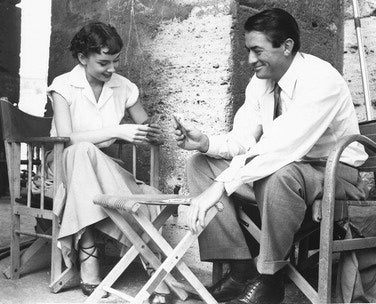 Audrey Hepburn and Gregory Peck in Roman Holiday movie scene, classic romantic film on Blu-ray