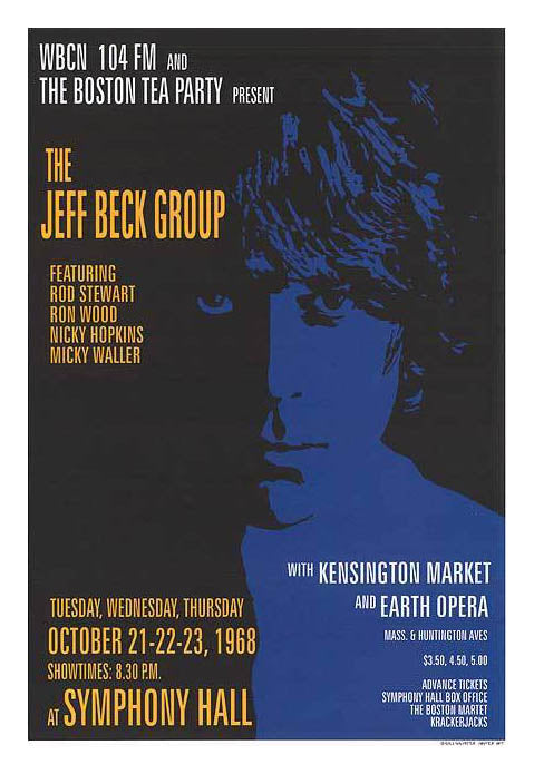 Front view of Jeff Beck performing live at Kensington Market venue, bathed in stage lights during peak guitar solo