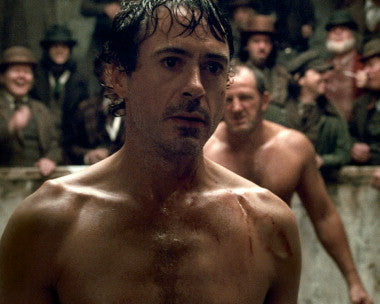 Sherlock Holmes and Robert Downey Jr. in an intense action scene.