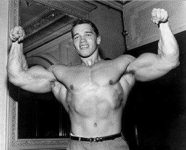 Arnold Schwarzenegger signed poster displayed on wall