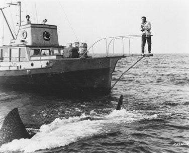 Jaws movie poster showcasing the iconic shark attacking a boat.