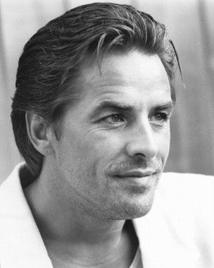 Authentic Don Johnson autographed photo showcasing his signature and a vibrant background.