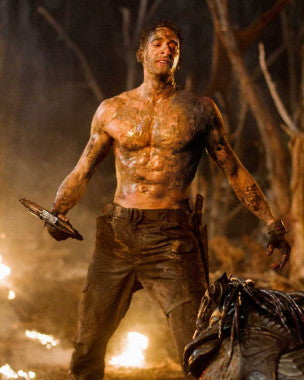 Adrien Brody in a scene from Predators, showcasing intense action and sci-fi elements