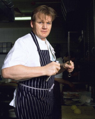Gordon Ramsay cookbooks and kitchen tools on a modern kitchen counter
