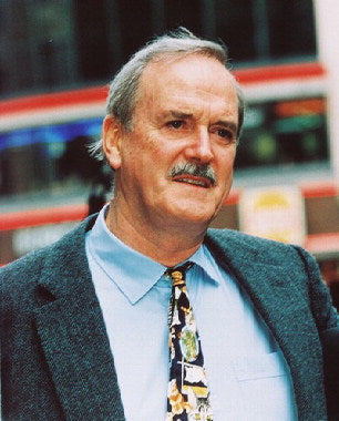 John Cleese performing a classic Monty Python sketch, showcasing his comedic talent.