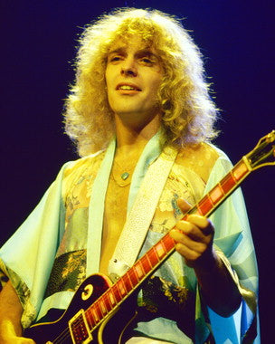 Peter Frampton performing live on stage, showcasing his guitar skills.