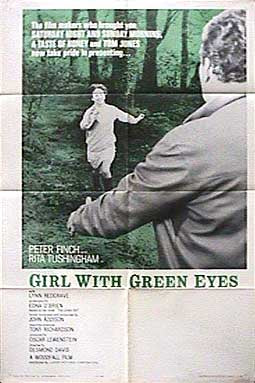 Woman applying eyeshadow to enhance her green eyes with natural makeup look