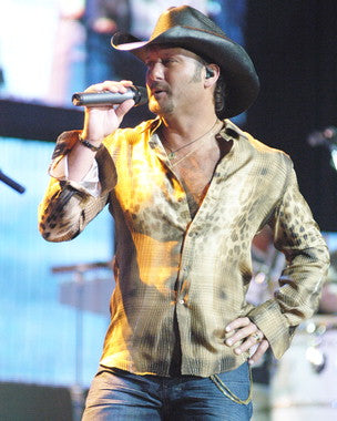 Tim McGraw performing live on stage, captivating the audience with his country music hits.