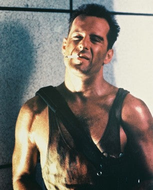 Bruce Willis as John McClane in Die Hard action scene with explosions