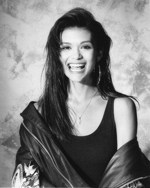 Nia Peeples performing live at a concert, showcasing her vibrant stage presence.