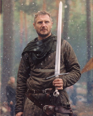 Liam Neeson in an action-packed scene from one of his thriller films, showcasing intense emotions.
