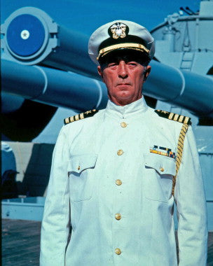 Close-up of a vintage war novel cover with Robert Mitchum's name