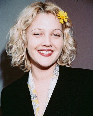 Drew Barrymore skincare products in elegant packaging for glowing skin