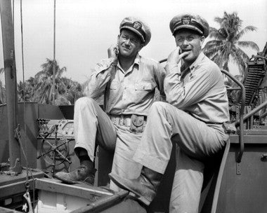 John Wayne in a dramatic scene from They Were Expendable, showcasing bravery in World War II.
