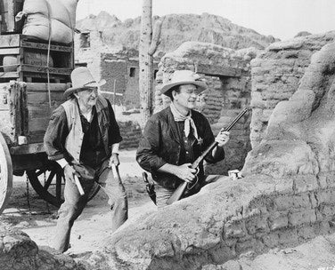 Rio Bravo movie poster showcasing John Wayne in a classic Western scene.