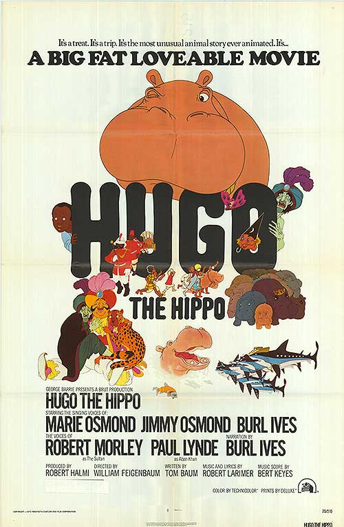 Hugo the Hippo plush toy lying on a bed, showcasing its soft plush fabric and playful expression
