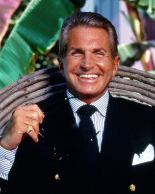 George Hamilton SunKissed Glow sunscreen bottle in soft light