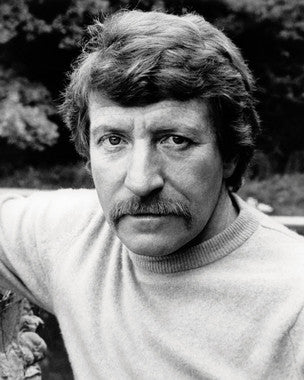 Clive Revill performing on stage with captivating expressions in a musical performance.